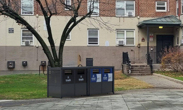 Trash & recycling enclosures with clear signage.